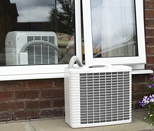 Portable air conditioner venting through window.