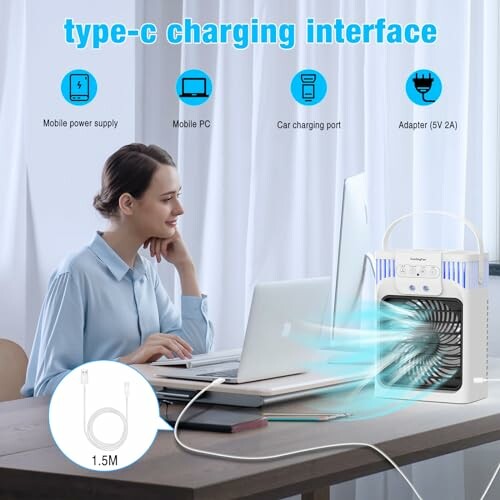 Woman using a portable air cooler with type-C charging on a desk.